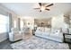 Open-concept living room featuring hardwood floors and neutral tones connects to kitchen and dining area at 221 Mountain Island Dr, Statesville, NC 28677