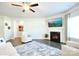 Bright living area boasts a fireplace and television at 221 Mountain Island Dr, Statesville, NC 28677