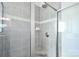 Tiled shower with glass door, featuring a shower head, soap dish, and neutral-toned color scheme at 221 Mountain Island Dr, Statesville, NC 28677