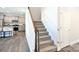 Carpeted staircase with a wooden handrail, adjacent to the kitchen with stainless steel appliances at 221 Mountain Island Dr, Statesville, NC 28677