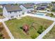 Aerial view of a backyard featuring a lush lawn, mature trees, privacy fence, a pool and pergola at 2220 Atwell Glen Ln, Pineville, NC 28134