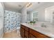 Bright bathroom featuring a double sink vanity, a patterned shower curtain, and modern fixtures for a fresh, clean look at 2220 Atwell Glen Ln, Pineville, NC 28134