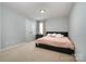 Inviting bedroom featuring a plush bed and neutral carpeting, creating a comfortable and relaxing retreat at 2220 Atwell Glen Ln, Pineville, NC 28134