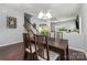 Charming dining room featuring hardwood floors, a classic chandelier, and comfortable seating for four at 2220 Atwell Glen Ln, Pineville, NC 28134