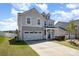 Charming two-story home with a two car garage, well-manicured lawn, and inviting front porch at 2220 Atwell Glen Ln, Pineville, NC 28134