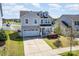 Charming two-story home with a two car garage, well-manicured lawn, and inviting front porch at 2220 Atwell Glen Ln, Pineville, NC 28134