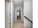 Upstairs hallway with carpeted floors leading to a bedroom visible through the doorway at 2220 Atwell Glen Ln, Pineville, NC 28134