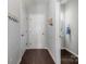 Downstairs hallway featuring wood look floors, coat rack, bathroom and access to the garage at 2220 Atwell Glen Ln, Pineville, NC 28134