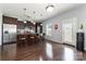 Features a stainless steel refrigerator, dark cabinetry and granite countertops with bar stool seating at 2220 Atwell Glen Ln, Pineville, NC 28134