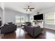 Spacious living room with hardwood floors, a ceiling fan, and plenty of natural light from the windows at 2220 Atwell Glen Ln, Pineville, NC 28134