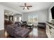 Inviting living room showcasing hardwood floors, comfortable seating, and a seamless transition to the kitchen at 2220 Atwell Glen Ln, Pineville, NC 28134