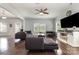 Open-concept living room with hardwood floors, neutral walls, and a view of the adjoining kitchen at 2220 Atwell Glen Ln, Pineville, NC 28134