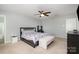 Bedroom features a ceiling fan, carpeted floors, ensuite bathroom, a dresser and night stands at 2220 Atwell Glen Ln, Pineville, NC 28134