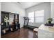 Home office space with desk, treadmill, shelving and a view out the window at 2220 Atwell Glen Ln, Pineville, NC 28134
