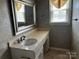 Elegant bathroom featuring a large mirror, vanity, updated fixtures, and wallpaper, creating a sophisticated retreat at 2417 Lynwood Dr, Lancaster, SC 29720