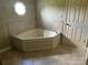 Bathroom with a large corner tub, octagon window and tiled floors at 2417 Lynwood Dr, Lancaster, SC 29720