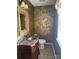 Elegant powder room boasting decorative wallpaper, a wood vanity, and a stylish mirror at 2417 Lynwood Dr, Lancaster, SC 29720