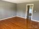 This bedroom features hardwood floors, a view into the Primary bath, and neutral colors at 2417 Lynwood Dr, Lancaster, SC 29720