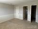 Spacious bedroom featuring neutral walls, carpeted floor, and multiple doorways offering great flexibility at 2417 Lynwood Dr, Lancaster, SC 29720