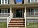 Welcoming front porch with a dark green front door, white columns, and classic brick steps at 2417 Lynwood Dr, Lancaster, SC 29720