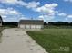 Spacious four-car garage with ample parking, complemented by a charming exterior and well-maintained surroundings at 2417 Lynwood Dr, Lancaster, SC 29720