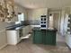 Bright kitchen featuring white cabinets, stainless steel appliances, a green island and tiled flooring at 2417 Lynwood Dr, Lancaster, SC 29720