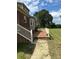 Inviting outdoor patio with brick flooring and white railings, perfect for relaxing and entertaining guests at 2417 Lynwood Dr, Lancaster, SC 29720