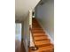 Staircase with hardwood steps, handrail, and white trim at 2417 Lynwood Dr, Lancaster, SC 29720