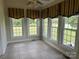 Bright sun room with many windows, tile floors and scenic backyard views, perfect for relaxing and entertaining at 2417 Lynwood Dr, Lancaster, SC 29720