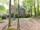 Spacious backyard with a large deck, mature trees, and a lush green lawn at 2805 Bathgate Ln, Matthews, NC 28105