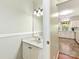 Convenient powder room featuring a vanity with a sink, a mirror, and modern lighting fixtures at 2805 Bathgate Ln, Matthews, NC 28105