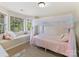 A cozy bedroom featuring a window seat, large window, carpet flooring, and a bed with a canopy at 2805 Bathgate Ln, Matthews, NC 28105