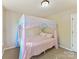 A cozy bedroom featuring carpet flooring, and a bed with a canopy at 2805 Bathgate Ln, Matthews, NC 28105