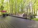 Expansive deck with outdoor seating and grill, ideal for entertaining amidst serene woodland views at 2805 Bathgate Ln, Matthews, NC 28105