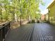 Wide shot of the large deck with lush greenery and a fence line, perfect for gatherings and relaxation at 2805 Bathgate Ln, Matthews, NC 28105