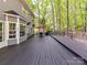 Exterior shot of the back of the house showing a large deck perfect for outdoor entertaining and relaxation at 2805 Bathgate Ln, Matthews, NC 28105