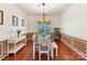 Formal dining room with hardwood floors, decorative molding, a large window, and an elegant chandelier at 2805 Bathgate Ln, Matthews, NC 28105