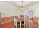 Spacious dining room with wainscoting detail and hardwood flooring, perfect for Gathering gatherings and entertaining guests at 2805 Bathgate Ln, Matthews, NC 28105