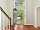 Grand entryway with high ceilings, hardwood floors, and a view of the home's exterior through the front door at 2805 Bathgate Ln, Matthews, NC 28105