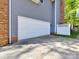 Two car garage showing brick and siding exterior, offering ample parking and storage at 2805 Bathgate Ln, Matthews, NC 28105