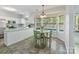 Bright kitchen features white cabinets, an eat-in breakfast nook, and large windows with a view of the backyard at 2805 Bathgate Ln, Matthews, NC 28105