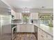 Bright kitchen with white cabinets, stainless steel appliances, and stylish tile backsplash, offering modern convenience at 2805 Bathgate Ln, Matthews, NC 28105