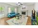 Cozy living room features a painted fireplace, large window, hardwood floors and a comfortable blue sofa at 2805 Bathgate Ln, Matthews, NC 28105