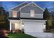 Charming two-story home with a two-car garage and beautifully landscaped front yard at 3013 Summit Oaks Rd, Charlotte, NC 28269