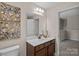 Bathroom features a dark wood vanity with decorative accents and modern lighting at 3060 Drummond Ave, Indian Land, SC 29707