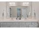 Bright bathroom features a long double vanity with a large mirror and modern lighting at 3060 Drummond Ave, Indian Land, SC 29707