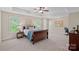 Bright bedroom features a trey ceiling, ceiling fan, and large windows overlooking the trees at 3060 Drummond Ave, Indian Land, SC 29707