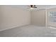 Bright bedroom features plush carpet, ceiling fan, and a large window for natural light at 3060 Drummond Ave, Indian Land, SC 29707