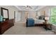 Bright and open bedroom offers two windows and a trey ceiling with modern ceiling fan at 3060 Drummond Ave, Indian Land, SC 29707