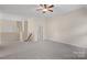 Large bonus room with neutral carpet, ceiling fan, and plenty of natural light at 3060 Drummond Ave, Indian Land, SC 29707